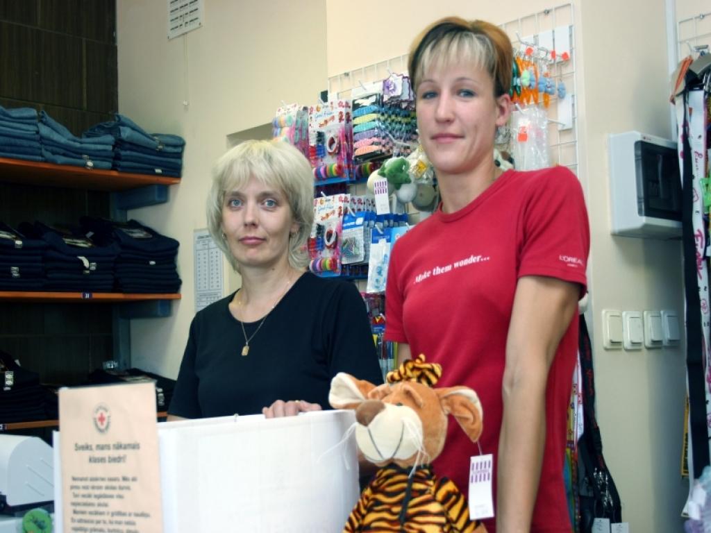 Veikala “Cenu paradīze” pārdevējas Antra Dzērveniece (no kreisās) un Inese Egle domā, ka līdz mēneša beigām ziedojumu kaste būs pilna. Foto: Gatis Bogdanovs