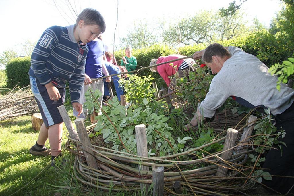 Ar lielu interesi bērni iesaistījās žoga pīšanā puķu dobēm. “Ozoldruvu” saimnieks Dailis Kadils (no labās) atklāja, ka šāds žogs kalpo pat vairākus gadus.
Autors: Gatis Bogdanovs 