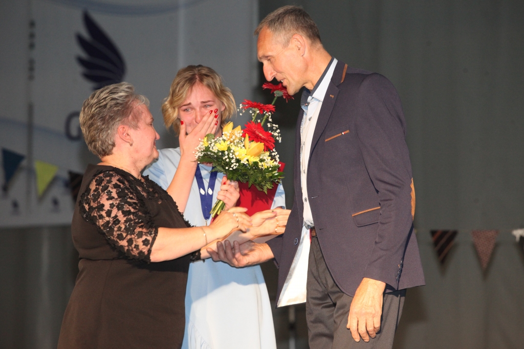 Sirsnīgs brīdis. Šajā mācību gadā Gulbenes novada valsts ģimnāzijā ir iedibināta jauna balva – Jovitas Cīrules piemiņas balva no gulbeniešu Cīruļu ģimenes. “Šī Jovitas Cīrules piemiņas balva mani ir iedvesmojusi jaunām lietām, “trakulībām” un sevis atklāšanai no jauna,” saka ģimnāziste Agnese Keita Birzniece. Balvas pasniegšanas brīdī Agnesei Keitai pievienojās tētis Andris - tas esot bijis vārdos neaprakstāms moments! Savukārt, kad pienāca Inese Cīrule (Jovitas Cīrules mamma – red.), ģimnāzistes emocijas lauzās un izlauzās. 		
Autors:  Gatis Bogdanovs