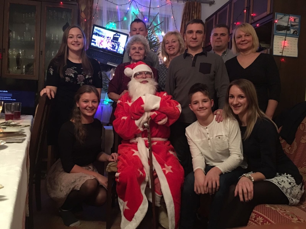 Ziemassvētku vecītis vai Salatētis šajā ģimenē nācis arī tad, kad mazu bērnu nav bijis, - tradīcija, kura pulcē kopā un dod prieku gan lieliem, gan maziem. 2018.gada svētkos: pirmajā rindā no kreisās - mazmeita Madara, Ziemassvētku vecītis jeb vectēvs, mazdēls Sandris, mazmeita Zane; otrajā rindā no kreisās - mazmeita Ance, vecmamma, dēls Sarmis, meita Inese; trešajā rindā – mazdēls Dāvis, vedekla Ilze un znots Igors, kā arī tiešsaistē datorā mazmeita Silga ar ģimeni.	
Autors: no personiskā arhīva